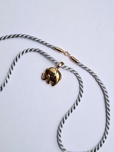 18 kt Gold Elephant Charm and 15.5 inch gray cord with 18 kt hook clasp. Simple and elegant pendant manufactured in France.  A lovely piece. Silver 14k Gold Necklace With Detachable Pendant, Elegant Gold Necklace With Adjustable Cord, Elegant Silk Cord Necklace For Gift, Gold Silk Cord Necklaces As Gift, Gold Pendant Necklace With Adjustable Cord, Gold Silk Cord Necklace For Gift, Gold Silk Cord Necklaces For Gifts, Elephant Necklace Gold Indian, Gold Elephant Bracelet