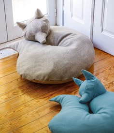 the cat bed is on the floor by the door