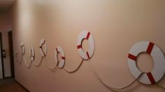 the wall is decorated with life preservers and letters that spell out'love '