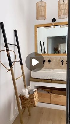 a room with a ladder, mirror and other items on the floor in front of it