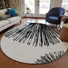 a living room with a white rug and blue chairs