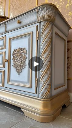 a large white and gold cabinet with ornate designs