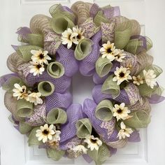 a purple wreath with white and green flowers