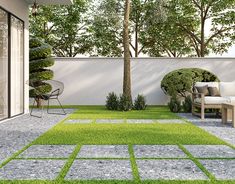 an outdoor patio with grass and stepping stones