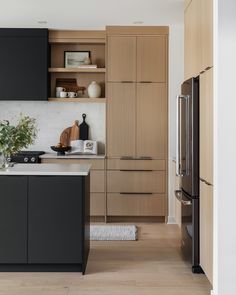 a kitchen with black cabinets and white counter tops