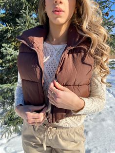 This wonderfully warm cropped puffer vest keeps out cold drafts while looking super stylish. Its relaxed fit feels roomy and can be worn over larger layers. A must have for your wardrobe. Details: - Model is 5'6" and is wearing size small - Zipper closure - Cropped fit - Care: Hand wash and hang to dry Brown Puffer Vest, Cropped Puffer Vest, Brown Puffer, Vests For Women, Padded Gilet, Puffer Vest, Stand Collar, Puffer, Collar