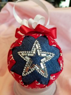 a red, white and blue ornament with a star on it