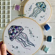 two embroidery hoops with jellyfish designs on them