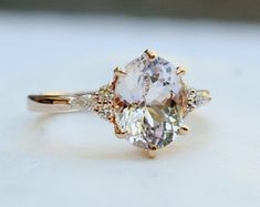 an oval cut engagement ring with three stone accents