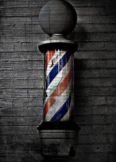 an old barber pole is painted red, white and blue