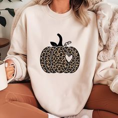 Leopard Pumpkin Shirt Sweatshirt Hoodie, Cheetah Pumpkin Shirt, Thanksgiving, Thankful Shirt,Fall Shirt, Hello Pumpkin,Family Matching We are trying to use always the highest quality brands like Bella Canvas and Gildan when they are available. Therefore the blend can slightly change due to stock levels. How to Order a T-Shirt: Review all the photos carefully. Choose your T-shirt color. Select your size. Click "Add to Cart." You can return to add more colors or complete your purchase. Click "Proceed to Checkout." Your custom shirt will be ready to ship within 1-3 business days. For bundle purchases, note that the price shown is for one item. To buy a bundle of two, place two separate orders. After purchasing, please message us with details about the print. Product Details: Side seams, retai Fall Leopard Print Cotton Tops, Leopard Print Cotton Tops For Fall, Fall Leopard Print Tops With Letter Design, Fall Leopard Print Top With Letter Details, Cheetah Pumpkin, Pumpkin Family, Leopard Pumpkin, Thankful Shirt, Hello Pumpkin