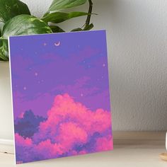 the sky is filled with pink clouds and stars art boarder on a table next to a potted plant