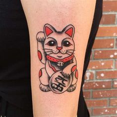 a woman with a cat tattoo on her arm