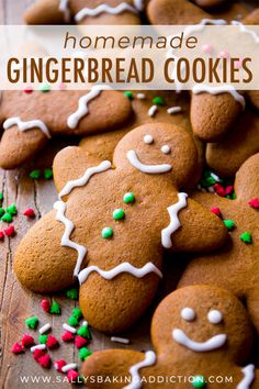 gingerbread cookies with white icing and sprinkles on a wooden surface