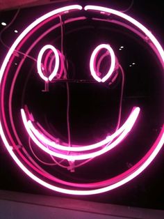 a neon sign with a smiley face on it