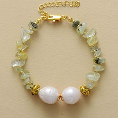 Elevate your style and spirit with the ✨ MantraChakra Baroque Pearl and Prehnite Bracelet ✨. Symbolizing purity, the baroque pearls harmonize with the heart-opening energy of vibrant prehnite stones. Embrace love, balance, and personal growth as you adorn your wrist with this captivating accessory. 💚✨ Materials: Gold Plated, Pearl, Purple Quartz Size: 6.7 -8.7 Inches Gold Baroque Pearl Bracelet With Pendant, Elegant Bracelet With Baroque Pearl Charm, Luxury Baroque Pearl Bracelet With Pendant, Yellow Gold Baroque Pearl Chain Bracelet, Luxury Baroque Pearl Charm Bracelets, Purple Quartz, Pearl Strands, Chakra Stones, Energy Crystals