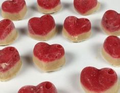 heart shaped cookies are arranged on a white surface