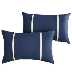 two navy blue pillows with white piping on the sides and one is in front