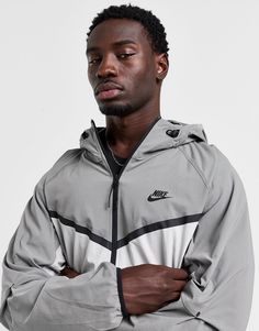 Layer up in signature Swoosh style with this men's Tech Woven Full Zip Hooded Jacket from Nike. In a Light Iron Ore and White colour block design, this relaxed-fit jacket is made with smooth, durable woven nylon fabric with added stretch for lasting comfort. It features a full-zip closure with stand collar and hood to amp up the coverage, while an elastic binding around the trims secures the fit. It has articulated elbows for a dynamic feel, and zipped pockets to stash your essentials. Finished with contrast taping to create the iconic Chevron design, and the legendary Swoosh logo at the chest. Machine washable. | Our model is 6'0" with a 36" chest and wears a size medium. Black Nike Tech, Chest Machine, Iron Ore, Woven Jacket, Chevron Design, Nike Tech, Swoosh Logo, Grey Nikes, Black Nike