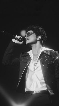 an image of a man singing into a microphone on his twitter account, with the caption bruno mars