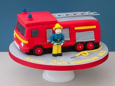 a birthday cake for a fireman with a red and yellow truck on the side