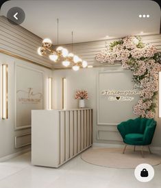 a white reception area with a green chair and flowers on the front desk, along with lights hanging from the ceiling