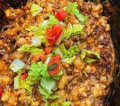 a bowl filled with meat and vegetables on top of a table