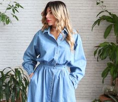 "✿ Vintage 1970's denim shirt dress. Features a point collar, buttoned placket, long sleeves and buttoned barrel cuffs. Relaxed /oversized puffed top with dropped sleeves, cinched waist and long flared skirt. Rear elastic half belt at rear and side waist button tap details. Dual side pockets. We love it paired with campus boots or vintage sandals and paired with a neck scarf. Great find! ✿ Fits like: Medium ✂ Measurements: ( taken laying flat ) Shoulders: 20\" Bust: 21\" Waist: 13\" un-stretched Long Sleeve Denim Dress For Daywear, Denim Blue Long Sleeve Shirt Dress With Buttons, Vintage Long-sleeve Denim Dress For Spring, Vintage Long Sleeve Denim Dress For Spring, Spring Vintage Long Sleeve Denim Dress, Relaxed Fit Denim Dress With Buttons For Daywear, Long Sleeve Denim Dress With Button Closure For Daywear, Vintage Long Sleeve Denim Dress With Pockets, Vintage Button-up Denim Dress For Spring