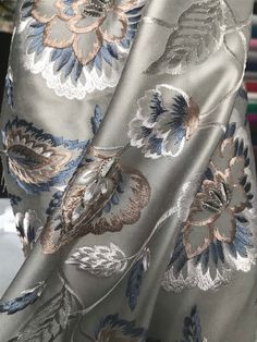 closeup of the back of a woman's dress with flowers and leaves on it