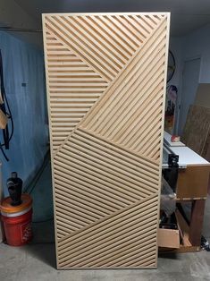 a large wooden door sitting in the middle of a room next to a workbench