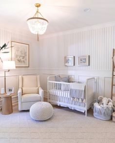 a baby's room with white walls and furniture