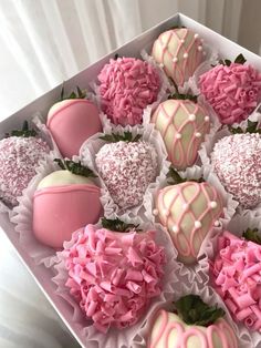 a box filled with pink and white chocolate covered strawberries