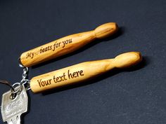 two wooden keychains with words written on them