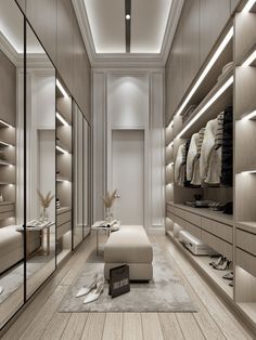 a large walk in closet with lots of drawers and lights on the ceiling above it