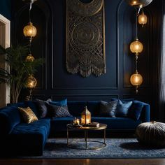 a living room with blue couches and gold accents on the walls, chandeliers hanging from the ceiling