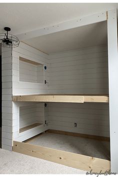 two bunk beds in a room with white walls and wood trim on the bottom half