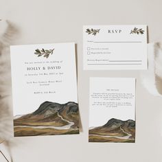 the wedding stationery is laid out on a table