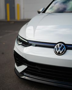 the front end of a white volkswagen car