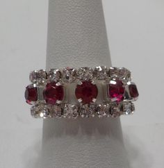 Vintage rhinestone stretch ring. Two rows of faceted & prong set clear rhinestones & one row of bright red, faceted, prong set red rhinestones, all of which are present and intact. Stretch ring size 7-12. Perfect for scarf adornment. This is an estate item--no info. Stretch Ring, Scarf Rings, Rhinestone Ring, Red Rhinestone, Multi Stone, Multi Stone Ring, Vintage Rhinestone, Clear Rhinestones, Stone Rings