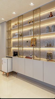 a white and gold display case in a room with many items on it's shelves