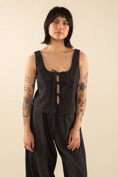 Cotton Blend Black Denim Tie Top Sleeveless Black Denim Top, Casual Black Denim Top For Spring, Black Denim Top For Summer, Black Cotton Top With Tie Straps, Black Cotton Tops With Tie Straps, Summer Black Denim Top, Spring Washed Black Denim Tops, Washed Black Sleeveless Top For Spring, Sleeveless Washed Black Spring Top