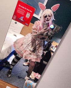 a woman dressed as a bunny holding a cell phone