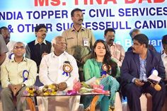 several people are sitting in front of a sign with india topper civil services and other successful candids