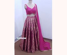 Made to Order/Measurement/Custom Order Lehenga - Color : Pink - Fabric : Banarasi Brocade - Flared Box Plated Banarasi Brocade lehenga skirt - Pink Blended Raw Silk Blouse  - Georgette Dupatta With Gold Lace PLEASE NOTE: BUYERS ARE RESPONSIBLE FOR ANY CUSTOMS AND IMPORT TAXES THAT MAY APPLY. Fabric Care : Dry Clean Only Disclaimer: Please note the photographs are taken by mobile camera in sunlight The actual color of the product might slightly differ due to exposure of light or monitor's display Fitted Silk Choli With Long Skirt, Anarkali Style Fitted Designer Skirt, Anarkali Fitted Skirt For Designer Wear, Fitted Pink Brocade Traditional Wear, Pink Brocade Lehenga With Self Design, Designer Zari Work Fitted Skirt, Designer Wear Skirt With Zari Work, Designer Wear Fitted Skirt With Zari Work, Designer Fitted Skirt With Zari Work