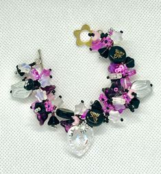 Step into a whimsical world with the Mystic Penguins & Emo Bees bracelet. This unique piece blends dark emo vibes with a touch of enchantment. Featuring black, pink, white, and silver beads, the bracelet is adorned with intricate bee motifs and a vintage German glass penguin charm. It's a stunning accessory that perfectly balances the moody and the magical, making it an unforgettable statement piece. Length of this bracelet is 6.5", please take your measurements before placing the order Magical Handmade Bracelets As A Gift, Whimsical Adjustable Beaded Bracelets For Party, Whimsical Handmade Beaded Bracelets For Party, Whimsical Beaded Bracelets With Charms, Bohemian Party Bracelets With Lobster Clasp, Bohemian Bracelets With Lobster Clasp For Party, Whimsical Handmade Purple Bracelets, Bracelet Wedding, The Mystic