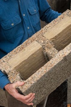 a man holding two blocks of cement in his hands