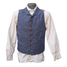 *This item is eligible for exchange or store credit only, no refunds. SPECS * An original MFSC®, inspired by late 1800’s gents’ waistcoats. * Fabric: 6.5 oz. 100% cotton indigo dyed denim 2×1 twill, solid white selvedge. * High buttoned, small fold lapel, slim snug silhouette. * Intricate early waistcoat panel construction. Tailor made style. * Adjustable back cinch strap with French New Old Stock (NOS) metal slide buckle. * Eight button front, brown corrozo wood, aka ‘coconut wood’. * Two fron Vintage Waistcoat, Denim Waistcoat, Retail Space Design, Dyed Denim, Striped Vest, Velvet Vest, French Silk, Wool Coats, Stripe Fabric