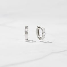 Classic huggie earrings featuring a solitaire stone. Great for stacking or worn on its own. Super versatile, chic and comfortable! Made of 925 Sterling Silver We use a THICK plating of 14k Gold or Rhodium - for a piece that will be with you for years to come! Inner Diameter: 9mm Width: 2mm Stone Size: 3.5mm Nickel-free & Hypoallergenic - great for sensitive ears!! Push Back Closure Happy to answer any questions you may have! 🥰 Classic Stackable Huggie Earrings For Gifts, Classic Stackable Huggie Earrings As Gift, Sterling Silver Stackable Huggie Earrings For Everyday, Everyday Stackable Sterling Silver Huggie Earrings, Everyday Sterling Silver Stackable Hoop Earrings, Elegant Silver Stackable Hoop Earrings, Classic White Gold Stackable Earrings, Stackable Sterling Silver Hoop Earrings, Elegant Stackable Sterling Silver Huggie Earrings