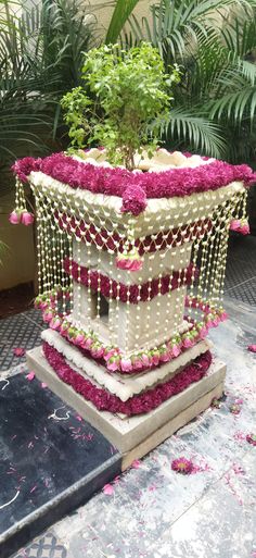 a decorative planter with pink flowers and greenery