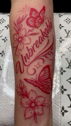 a woman's leg with red ink and butterflies on it